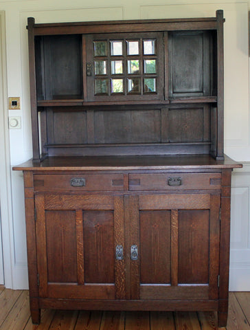 <p>Antique Arts & Crafts oak sideboard circa 1900. Solid, heavy piece with glazed cupboard on the top section.</p>