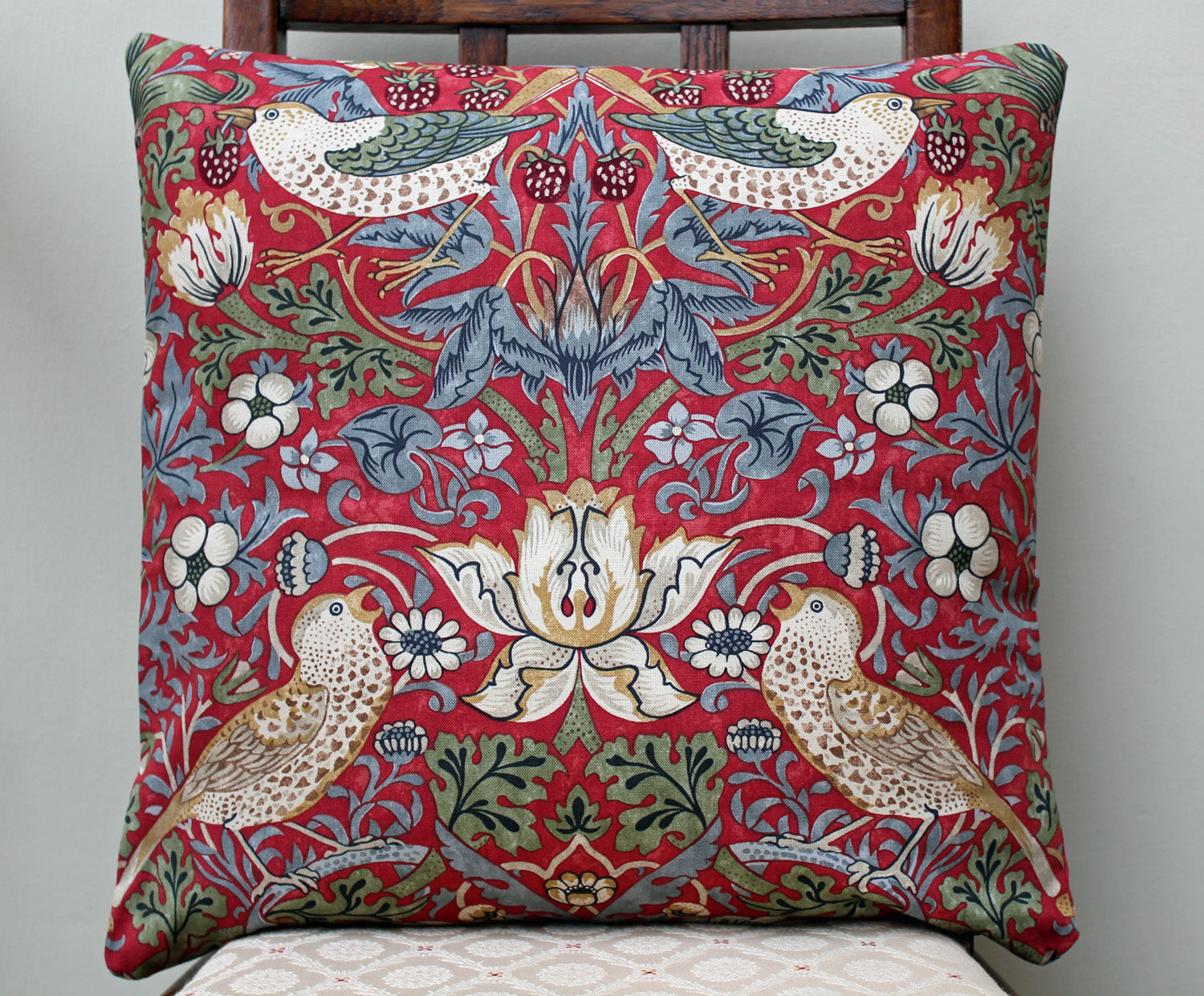 <p>Cushion with duck feather inner pad in William Morris Strawberry Thief crimson print. Morris & Co. by Sanderson fabric.</p>